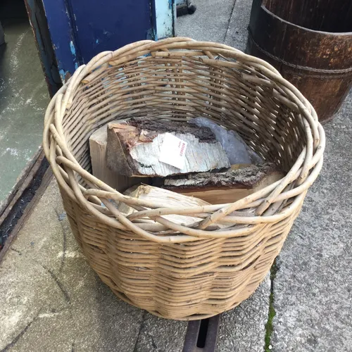 Woven log basket with logs