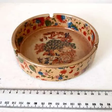 Yellow/gold ashtray with peacock design