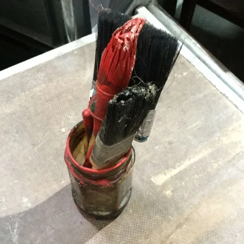 Glass jar with used paintbrushes
