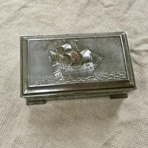 Small silver trinket box with raised ship design