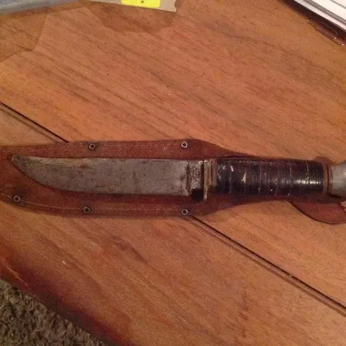 Period rustic hunting knife in leather sheaf