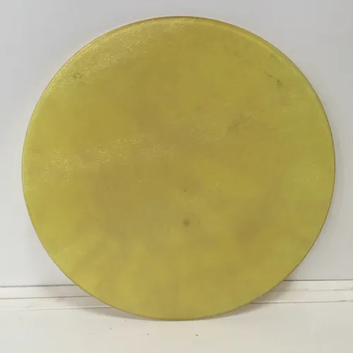 Circular yellow glass chopping board 
