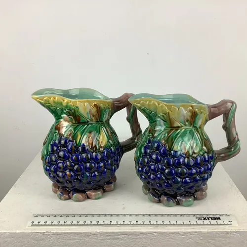 Pair of glazed Majolica jugs with grape design