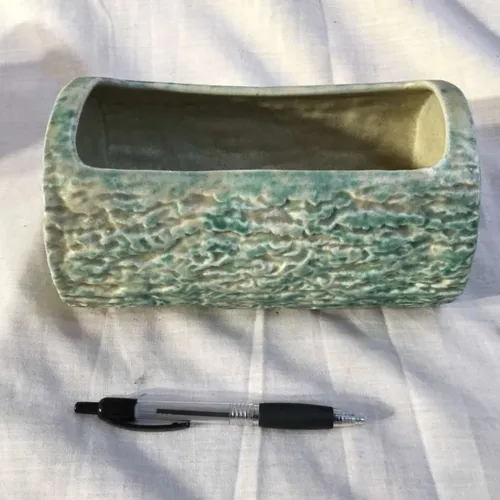 Green ceramic log planter