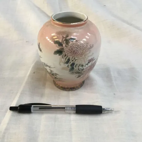 Small pink and white vase with flower decoration