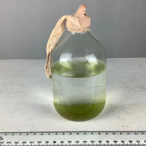 Glass measuring bottle with rubber tubing