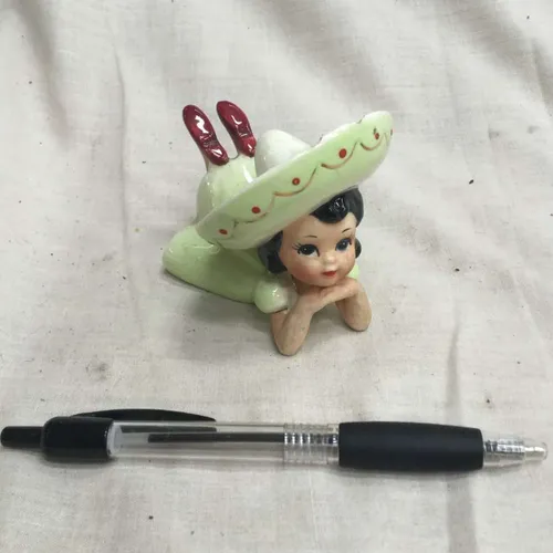 China figurine of girl in green dress and sombrero 