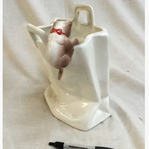 Cat climbing into bag ceramic ornament 