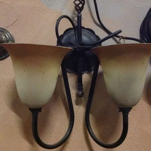 black metal wall light with orange white glass shade