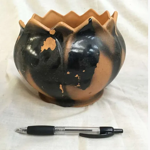 Black and terracotta planter with jagged edge 