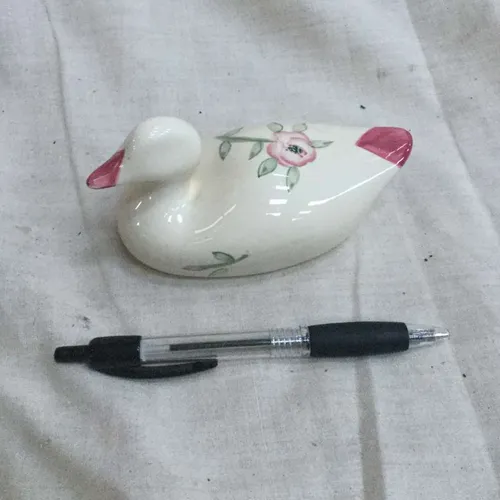 White ceramic duck ornament with pink floral details