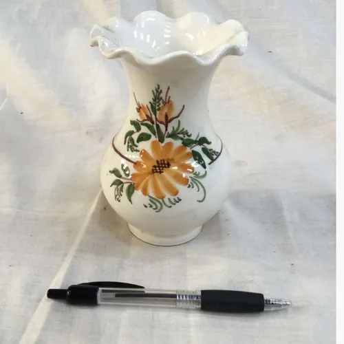 Small glazed ceramic vase with hand painted orange floral details and scalloped edge