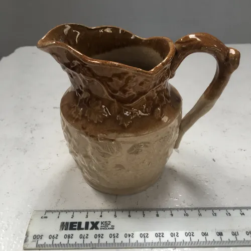 Small brown and cream glazed ceramic jug 