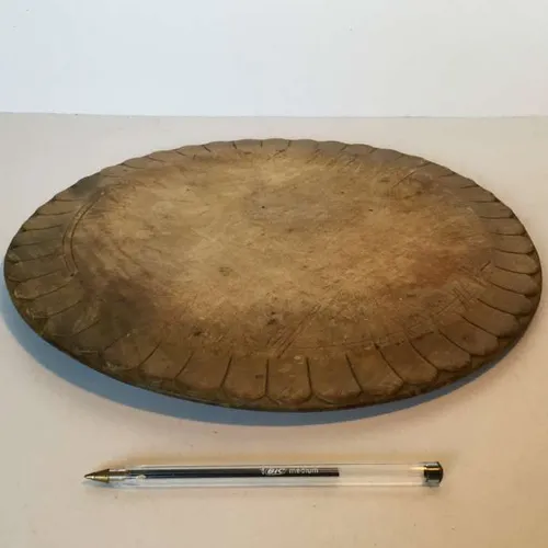 period circular wooden chopping board with decorative edge