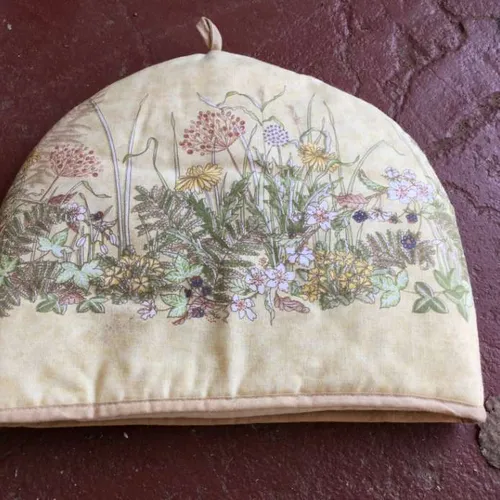 beige tea cozy with floral design
