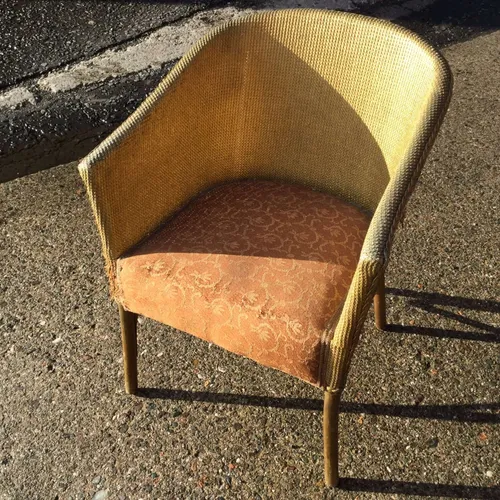 Gold Wicker Rattan Chair with orange seat cover with swirl 