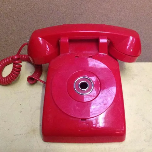 red corded telephone with covered push button dial panel