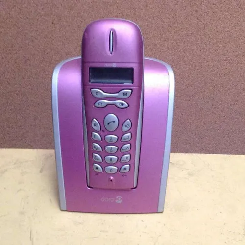 metallic pink Doro 525 cordless push button telephone with base