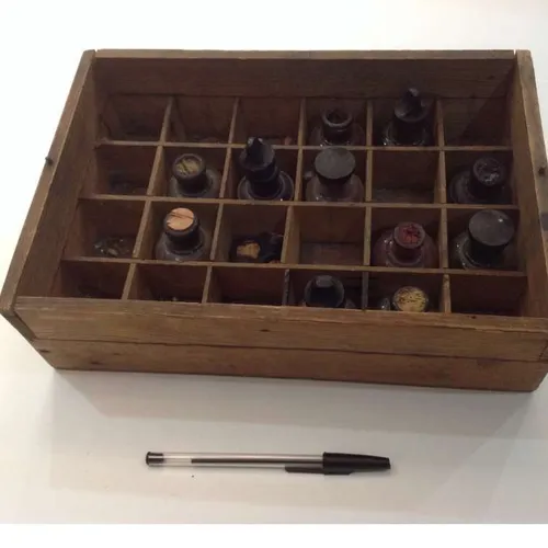 distressed wood box with well-worn ink bottles
