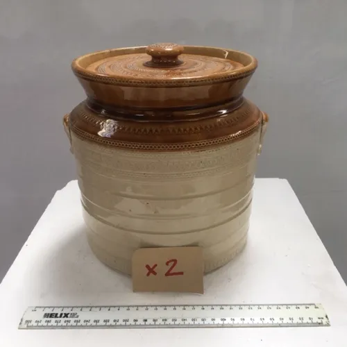 Large cream and tan stoneware jar with lid