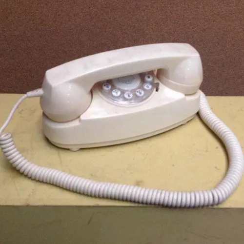 white corded push button telephone
