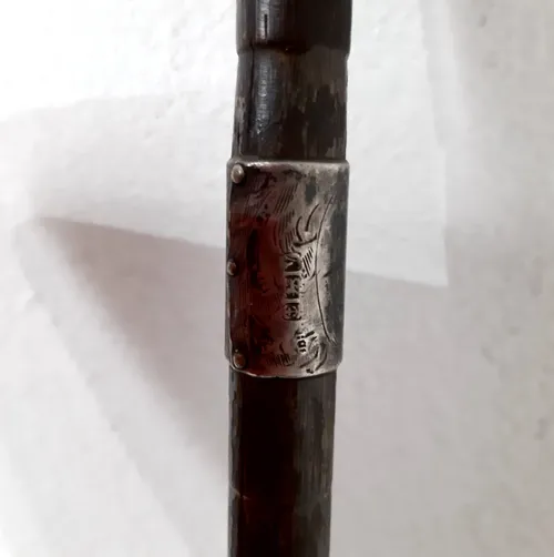 Dark wood thin walking stick with silver plaque detail