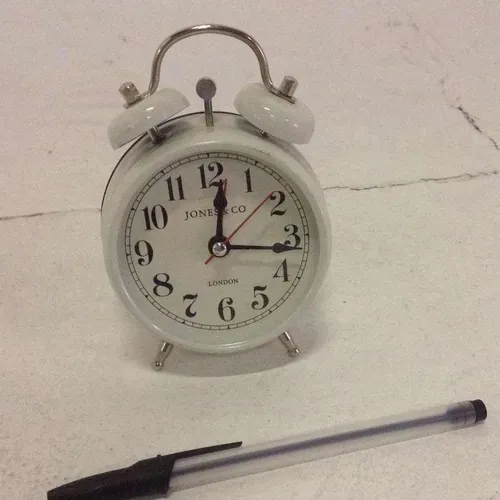 Jones and Co white analogue twin bell alarm clock with white face and glass face cover