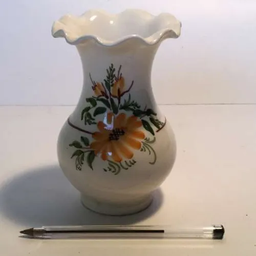 white glazed vase with yellow and green floral design flared top and waved rim