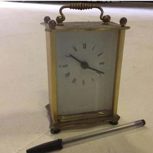 brass metal analogue mantle shelf clock with white face