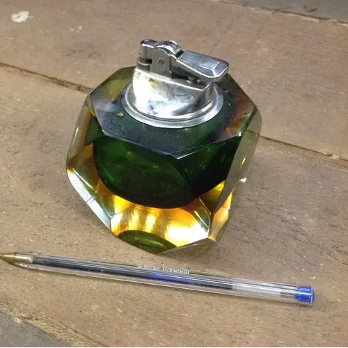 green and yellow glass table top lighter