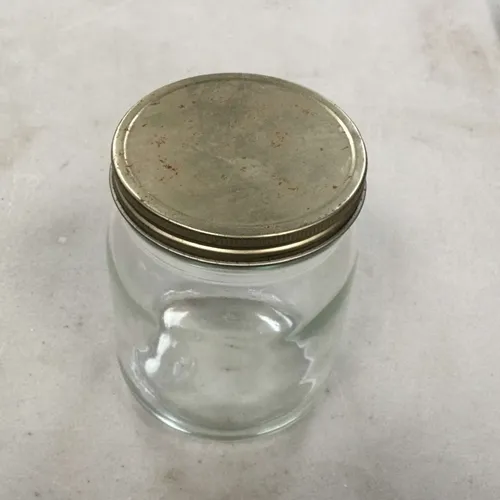 Small glass jar with gold lid