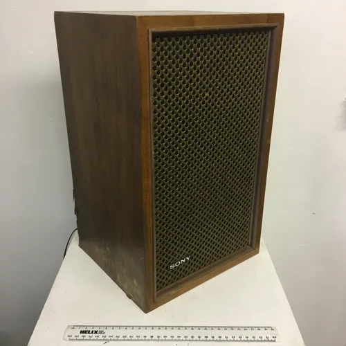Pair of vintage Sony speakers in wood surround with honeycomb mesh.