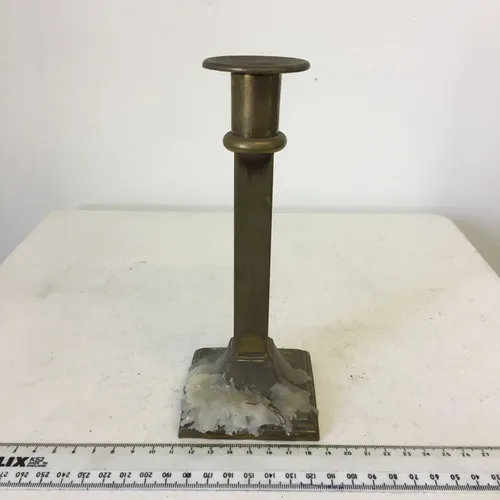 Square based brass candlestick with wax