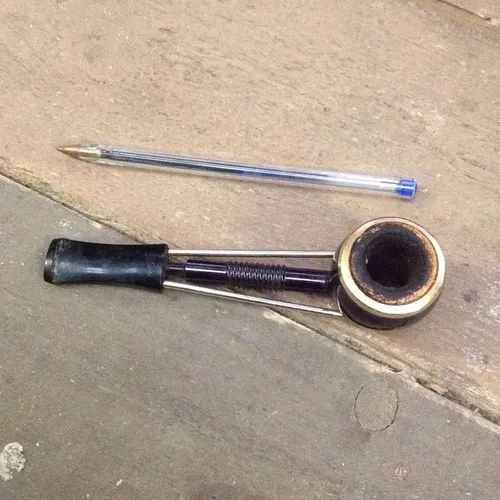 black and metal Apple pipe