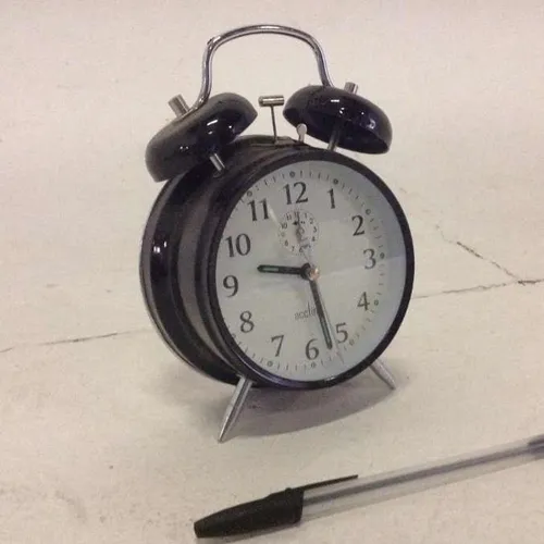 Acctim black analogue twin bell wind up alarm clock with white face and glass face cover