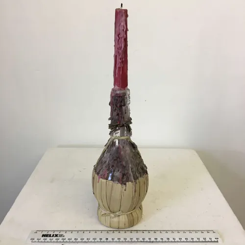 Wax candle in a glass fiasco bottle 