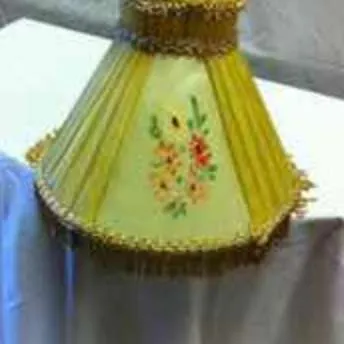 Small period lampshade with yellow fabric pleats and floral panels