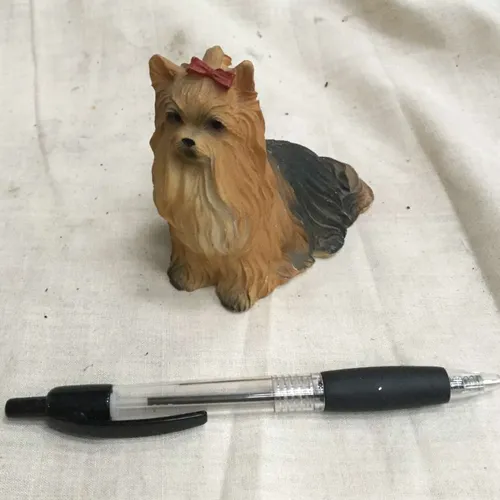 Small brown dog with bow ornament