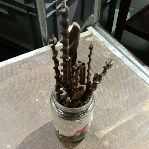 Glass with rusty drill bits