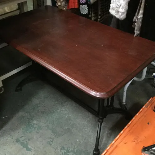 Rectangular dark wood table with black cast iron legs