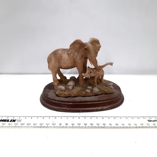 Mother and baby elephant on wooden base