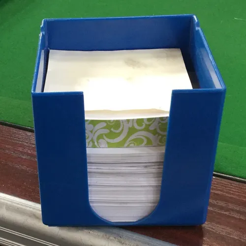 Various coloured plastic notepaper holders with paper