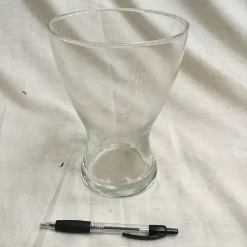Glass vase with curved in base