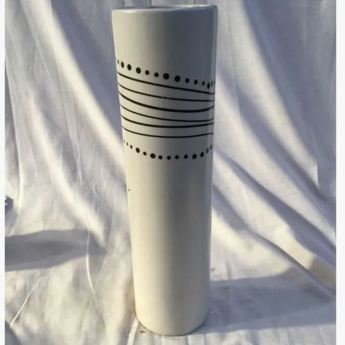 Tall white cylindrical ceramic vase with black spots and stipe detail 