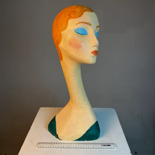 Polystyrene female bust with elongated neck, red hair and blue eye shadow