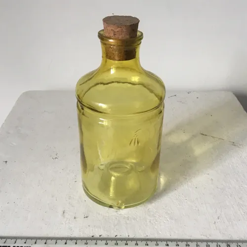 Yellow Glass bottle, cork top, hole in bottom