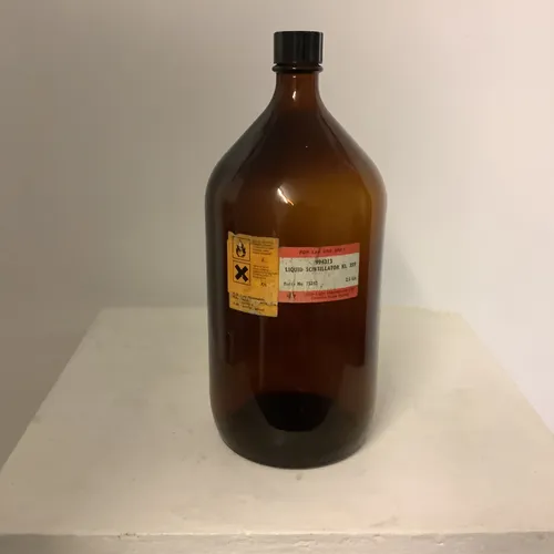 Tall brown glass “Liquid Scintillator” bottle