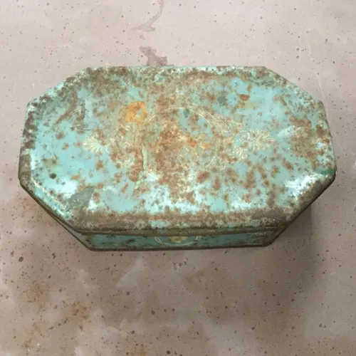 Rusted pale blue tin