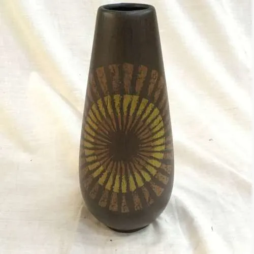 ceramic brown vase with orange and yellow sun design