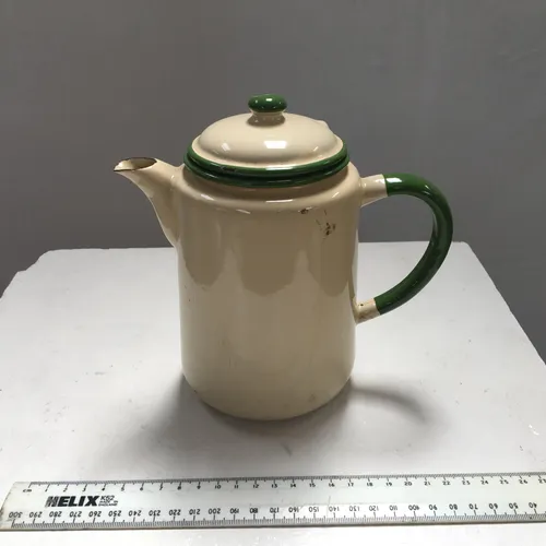 cream enamelware coffee pot with green rim and handle with matching lid